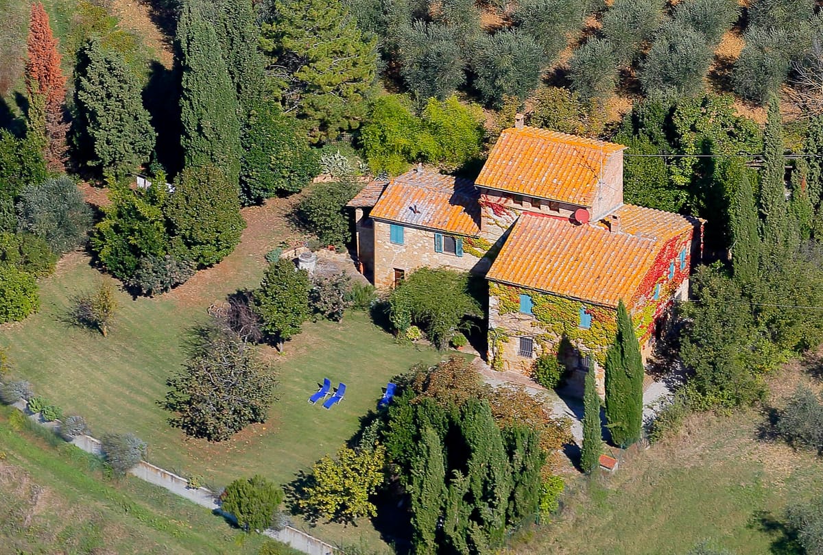 Podere Colombaio seen from above, with the lawn and the white road