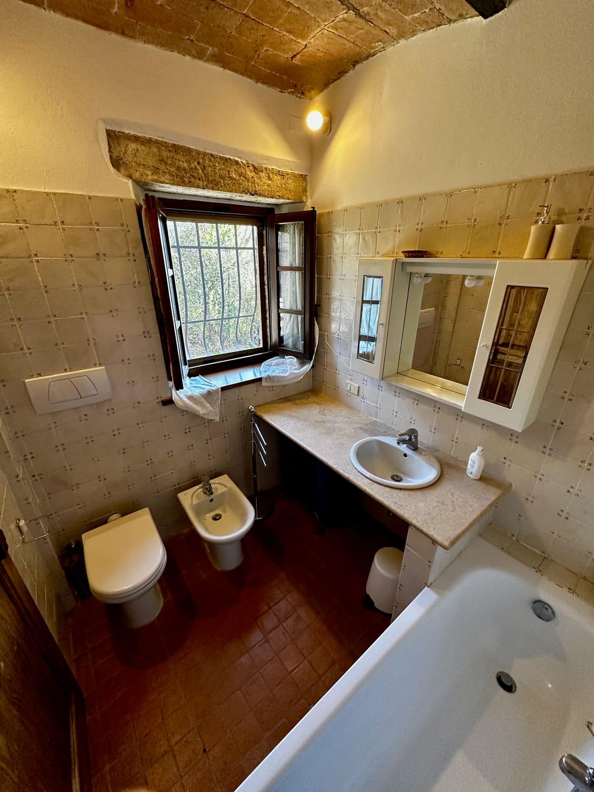 The bathroom with bathtub, marble basin and stone window