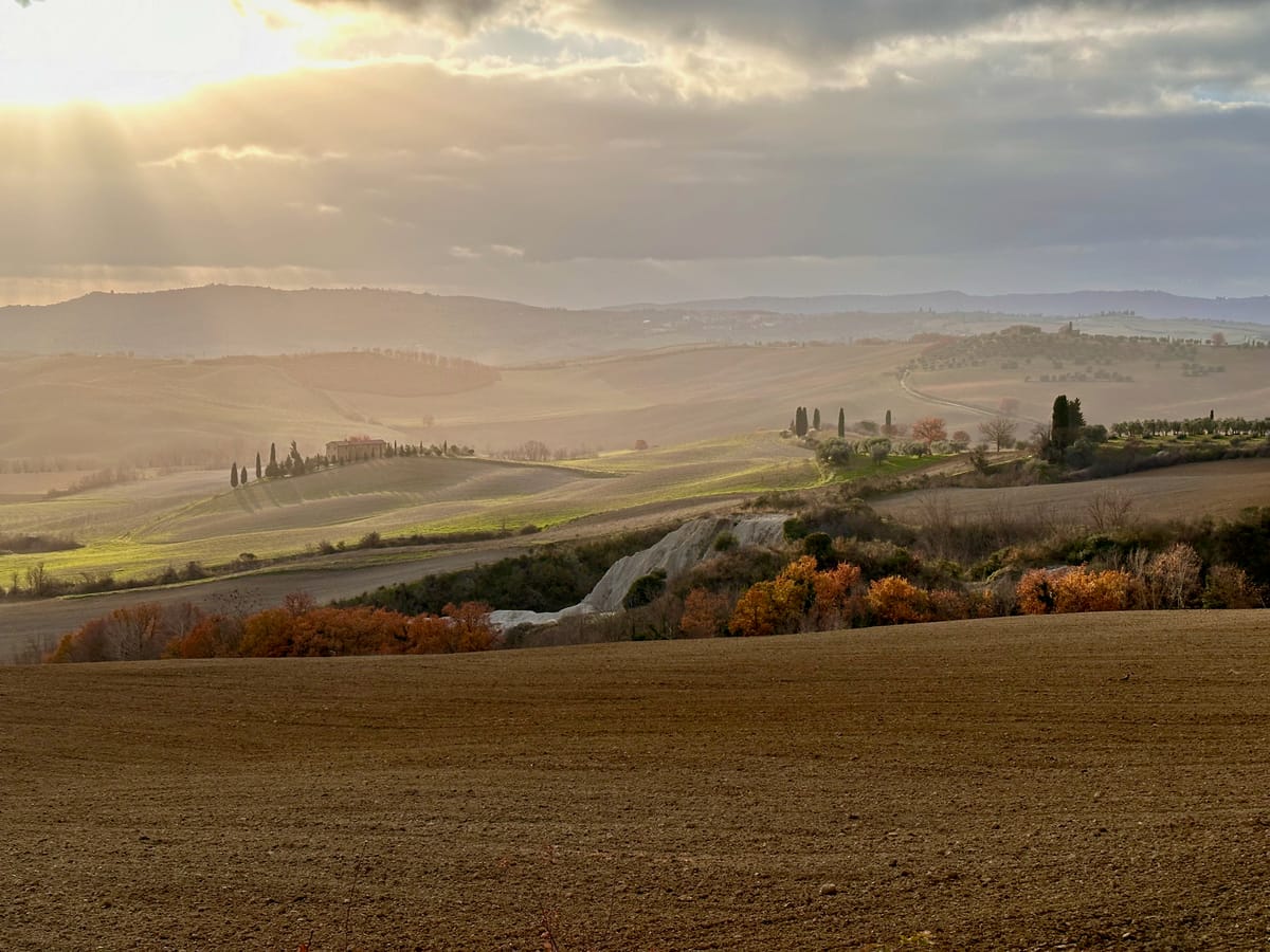 Winter light between the clouds over the Val d'Orcia hills