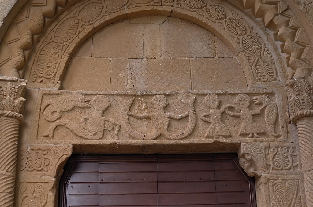 The two-tailed siren carved on the portal lintel of the Pieve di Corsignano
