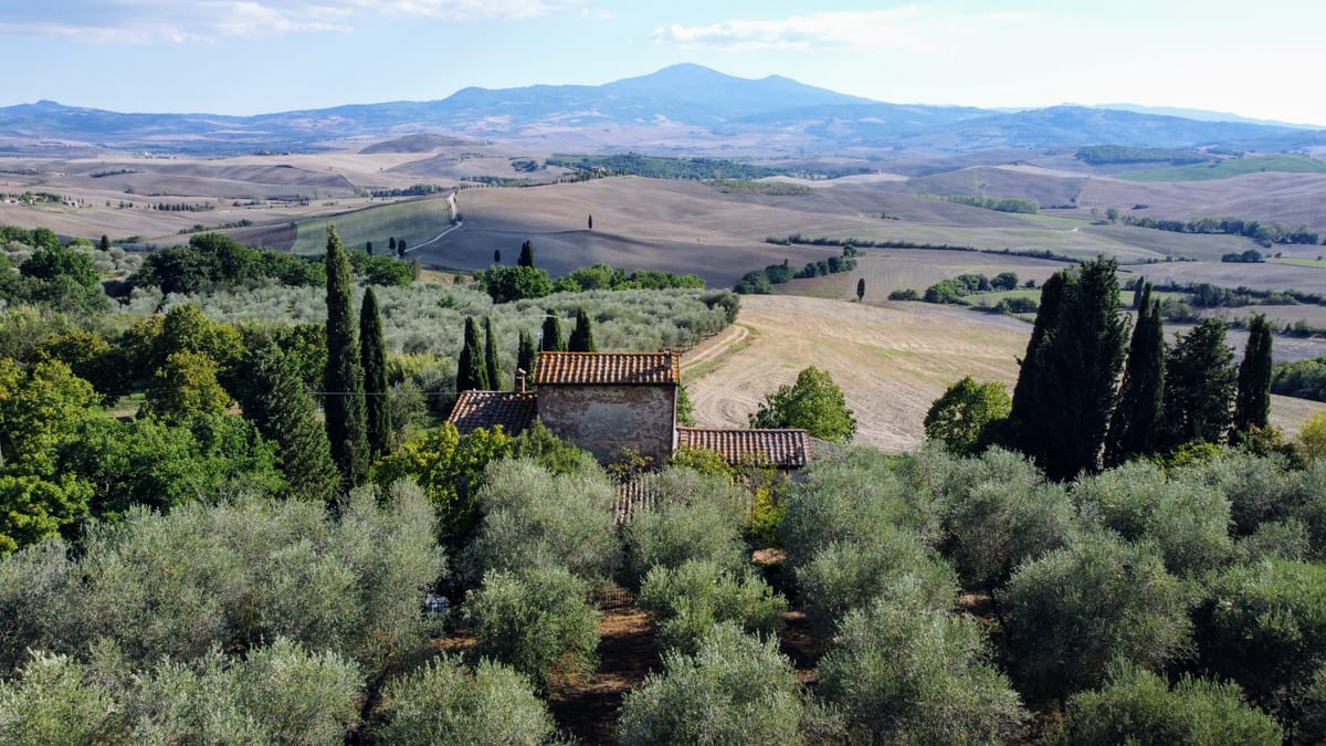 The Val d'Orcia by drone: the farmhouse roof in the foreground and Monte Amiata beyond
